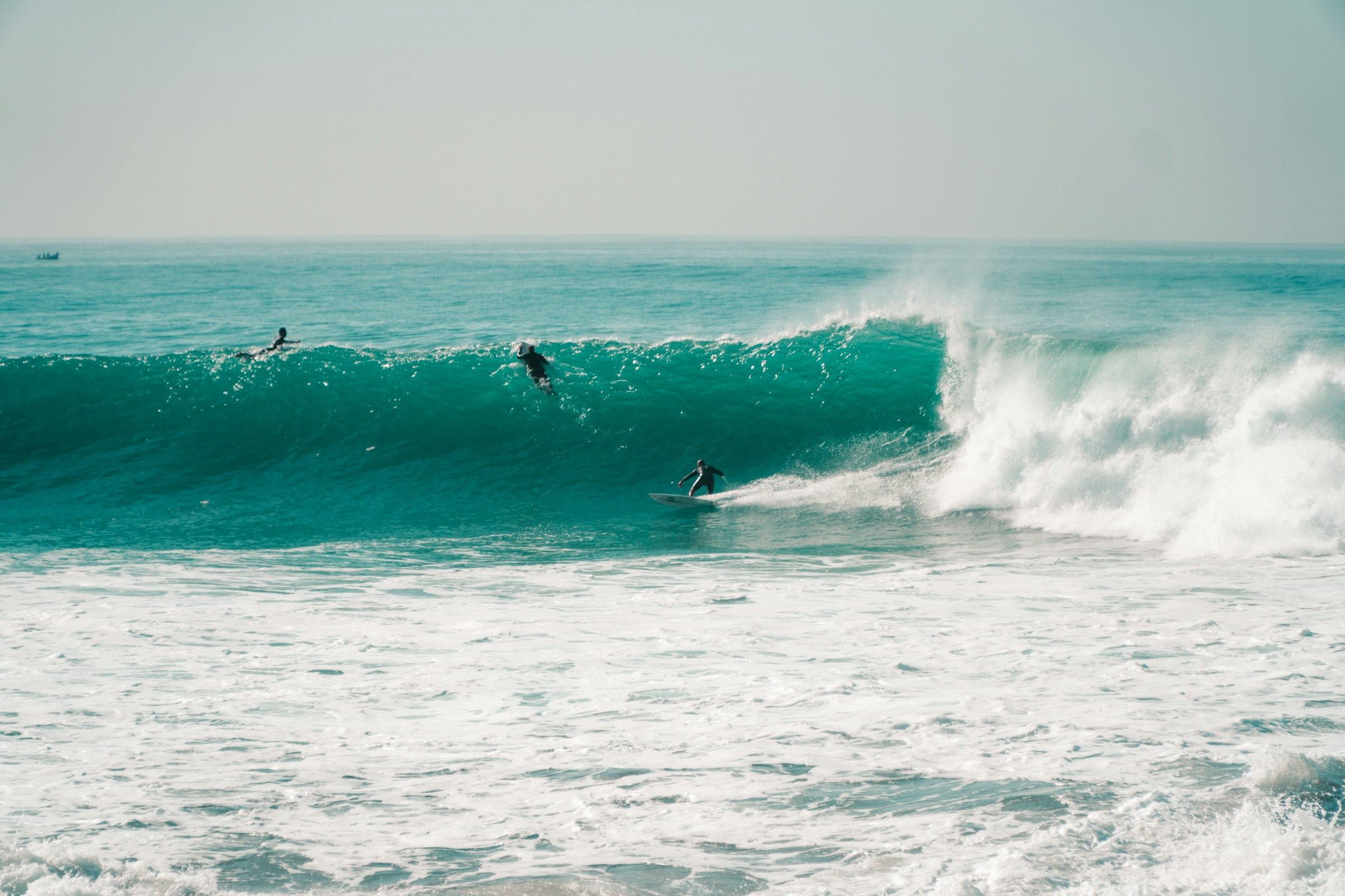 Surfers riding a clean wave at Anchor Point, Taghazout
