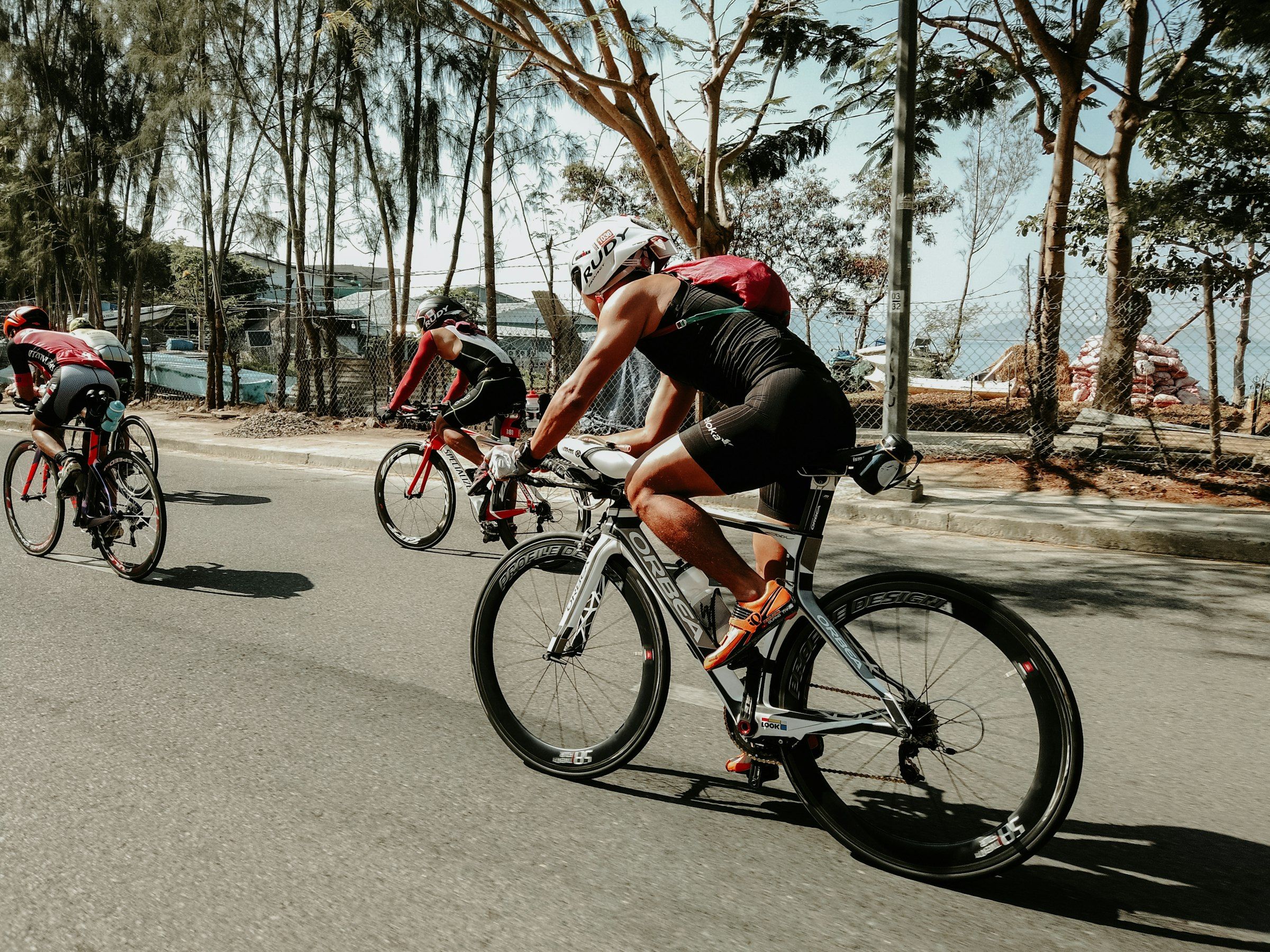 Triathlete on a time-trial bike riding along a seaside road